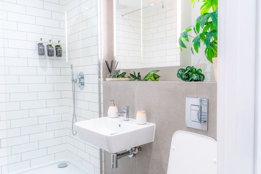 Shower room with metro tiles, a wall-hung basin and plants