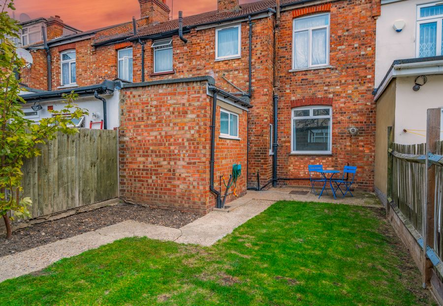 Rear garden with a lawn and brick extension