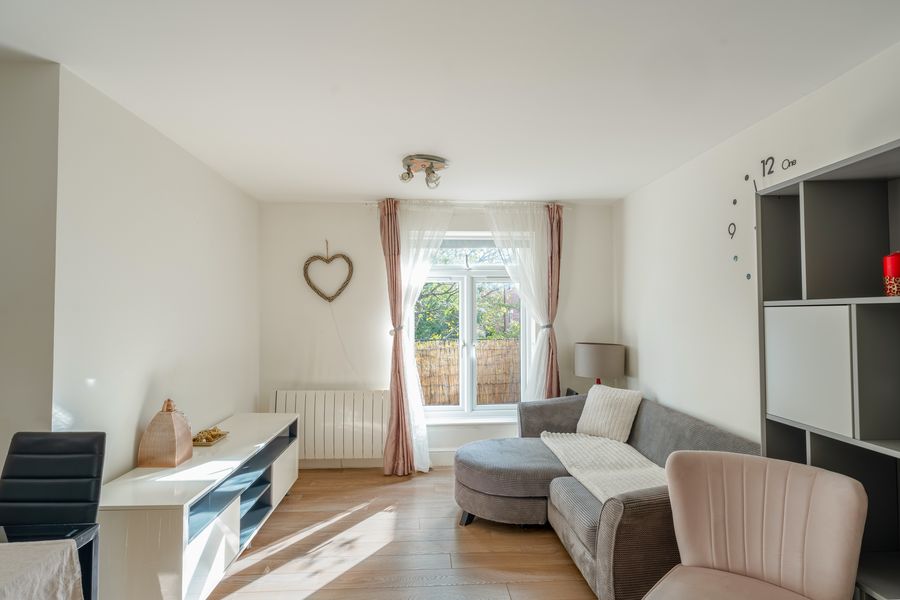 Living room with a corner sofa and a French window