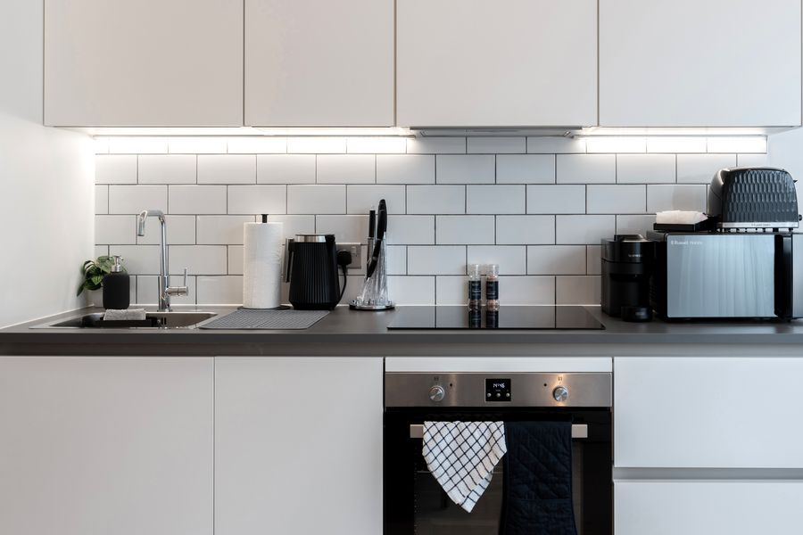 White kitchen with metro tiles and under-cabinet lights